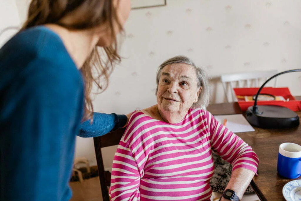 eldery woman in looking at woman